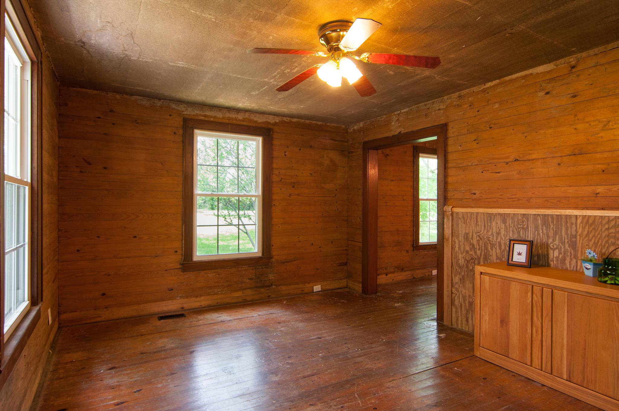 4455 Cato Road Nashville, TN 37218 - Photo 3 of 30 The living room from the front door. Real hardwood floors just need refinishing. The walls and ceilings in this home are solid wood too.