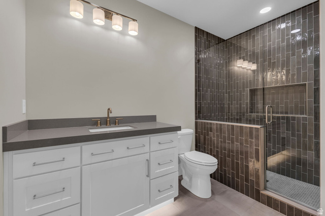 2828 Jojo Road Eagle Mountain, UT 84005 - Photo 46 of 63 Contemporary bathroom featuring a spacious white vanity with a dark countertop and an undermount sink
