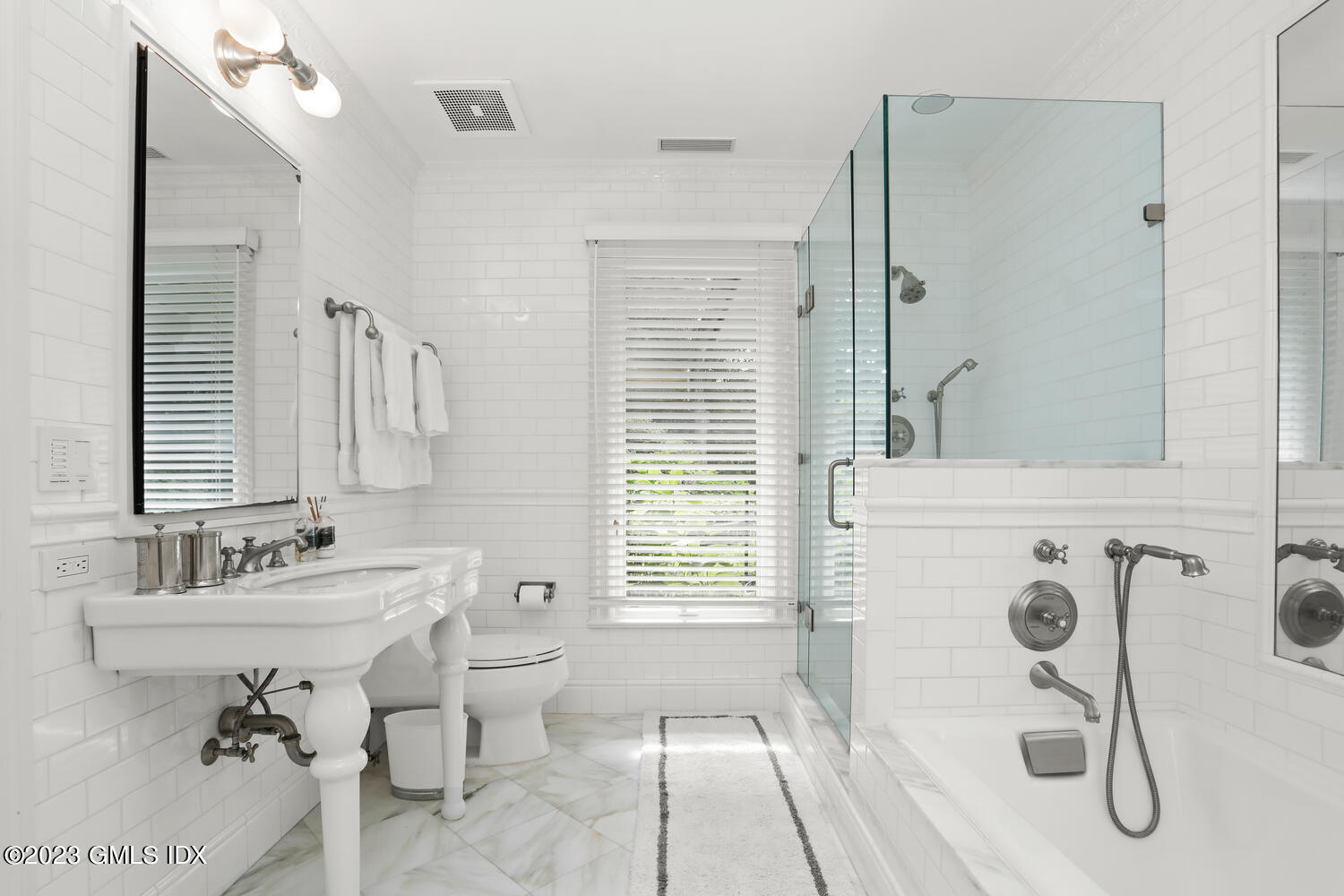 101 Perkins Road Greenwich, CT 06830 - Photo 23 of 41 a bathroom with a sink toilet a mirror and shower