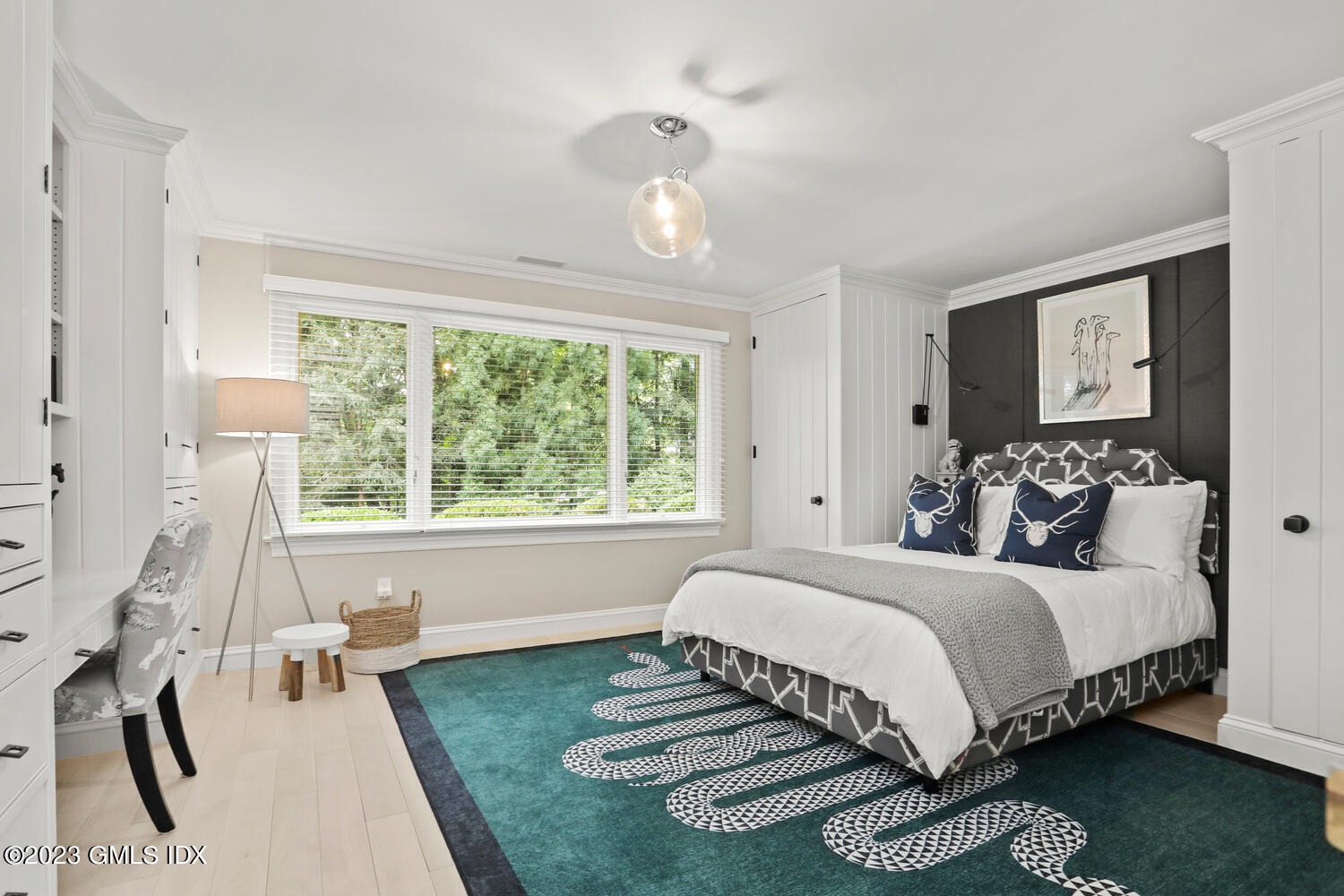 101 Perkins Road Greenwich, CT 06830 - Photo 24 of 41 a bedroom with a bed wooden floor and a large window