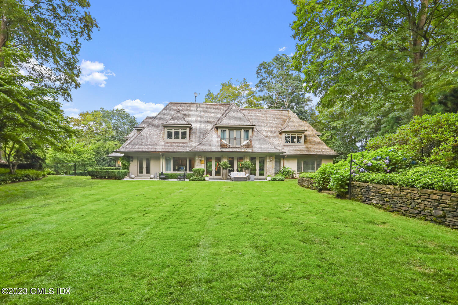 101 Perkins Road Greenwich, CT 06830 - Photo 30 of 41 a front view of a house with a garden