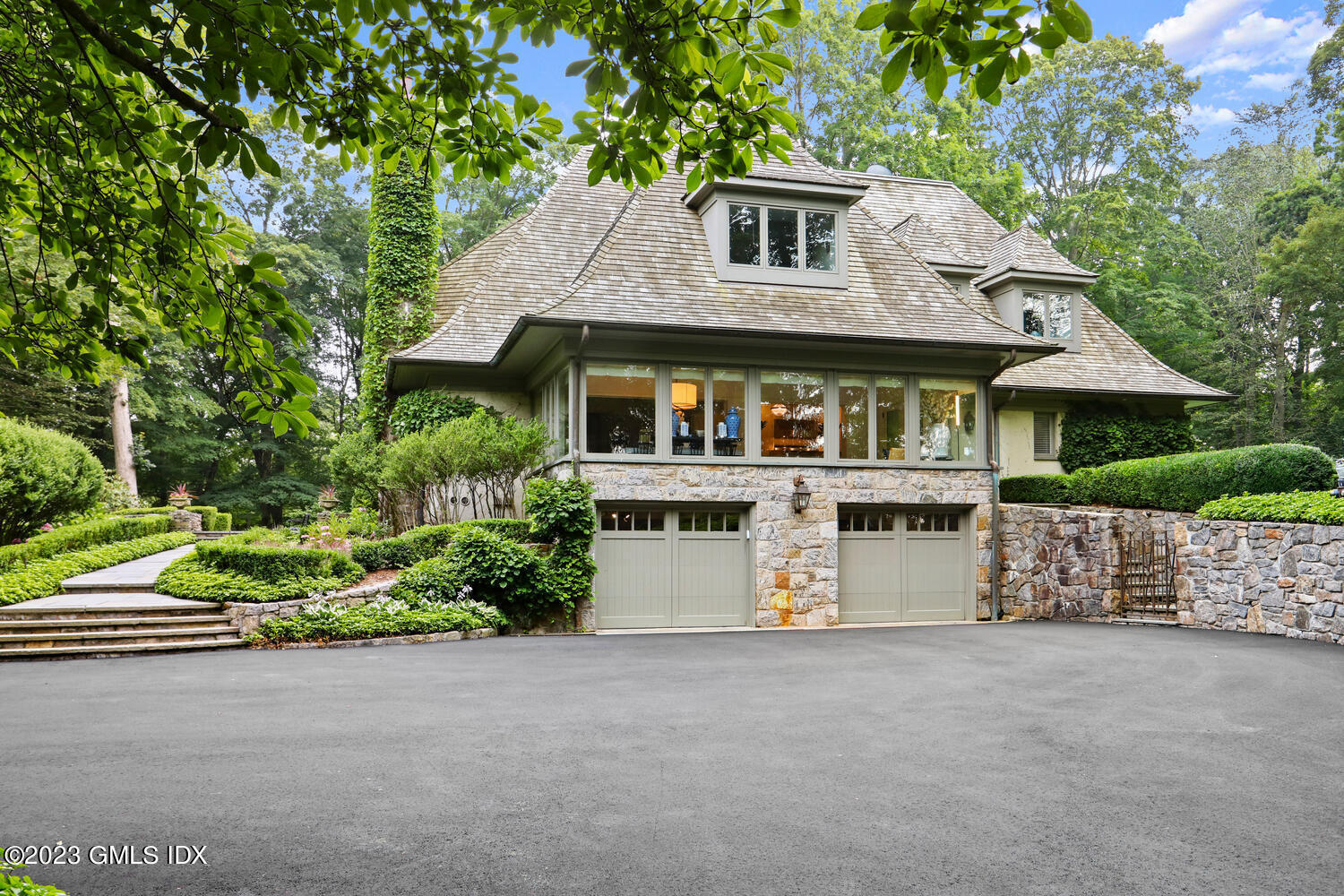 101 Perkins Road Greenwich, CT 06830 - Photo 35 of 41 a front view of a house with a garden