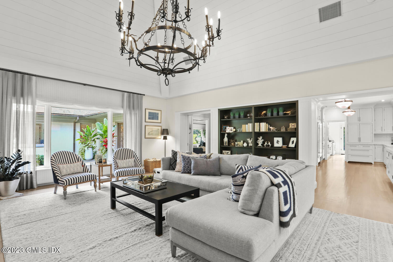 101 Perkins Road Greenwich, CT 06830 - Photo 7 of 41 a living room with furniture a chandelier and a dining table with wooden floor