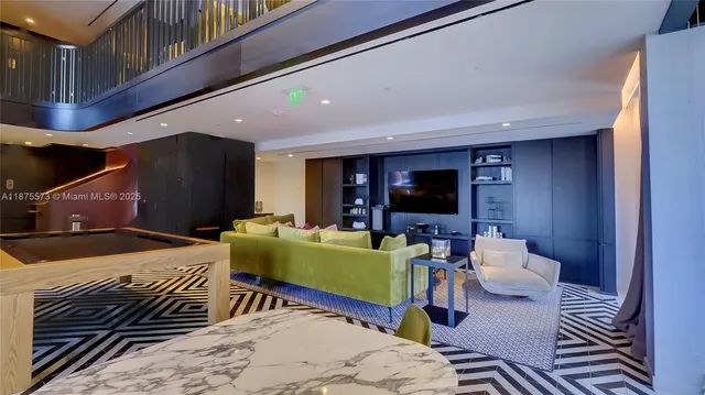 a living room with furniture mirror and floor to ceiling window