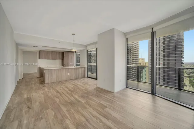 a view of a room with wooden floor and white walls