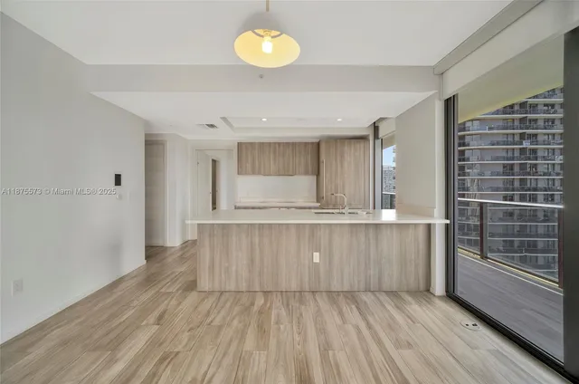 a view of kitchen with wooden floor and window