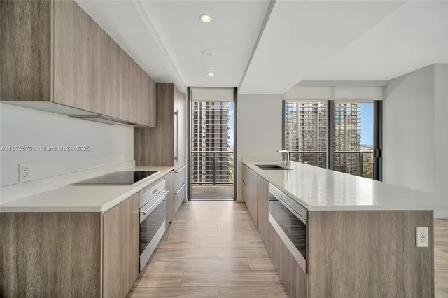 a large white kitchen with a large window
