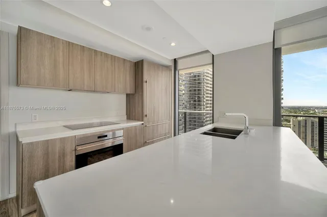 a kitchen with a stove a refrigerator a sink dishwasher and wooden cabinets with wooden floor