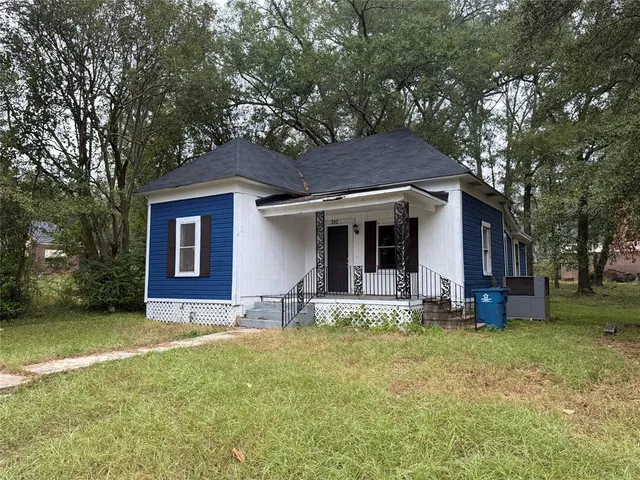 a house that has a tree in front of it