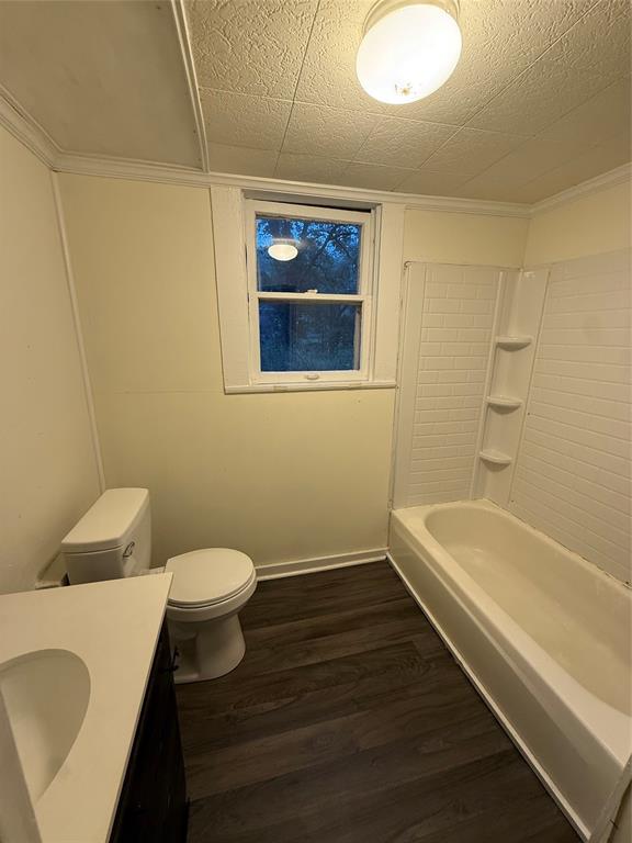 310 West Tennessee Avenue Vivian, LA 71082 - Photo 6 of 8 a bathroom with a sink a toilet and bathtub