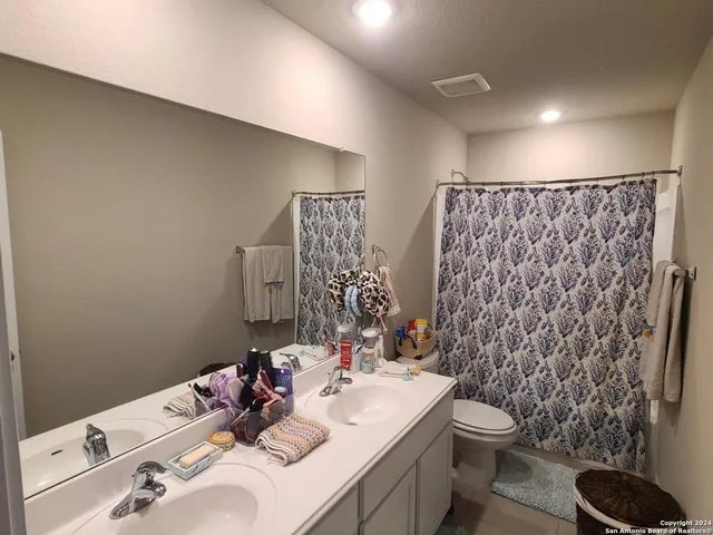 a bed room with a bed and a chair