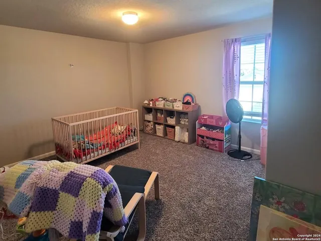 a bedroom with furniture and a flat screen tv