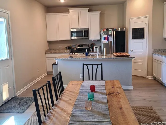 a kitchen with stainless steel appliances kitchen island granite countertop a refrigerator stove microwave and sink