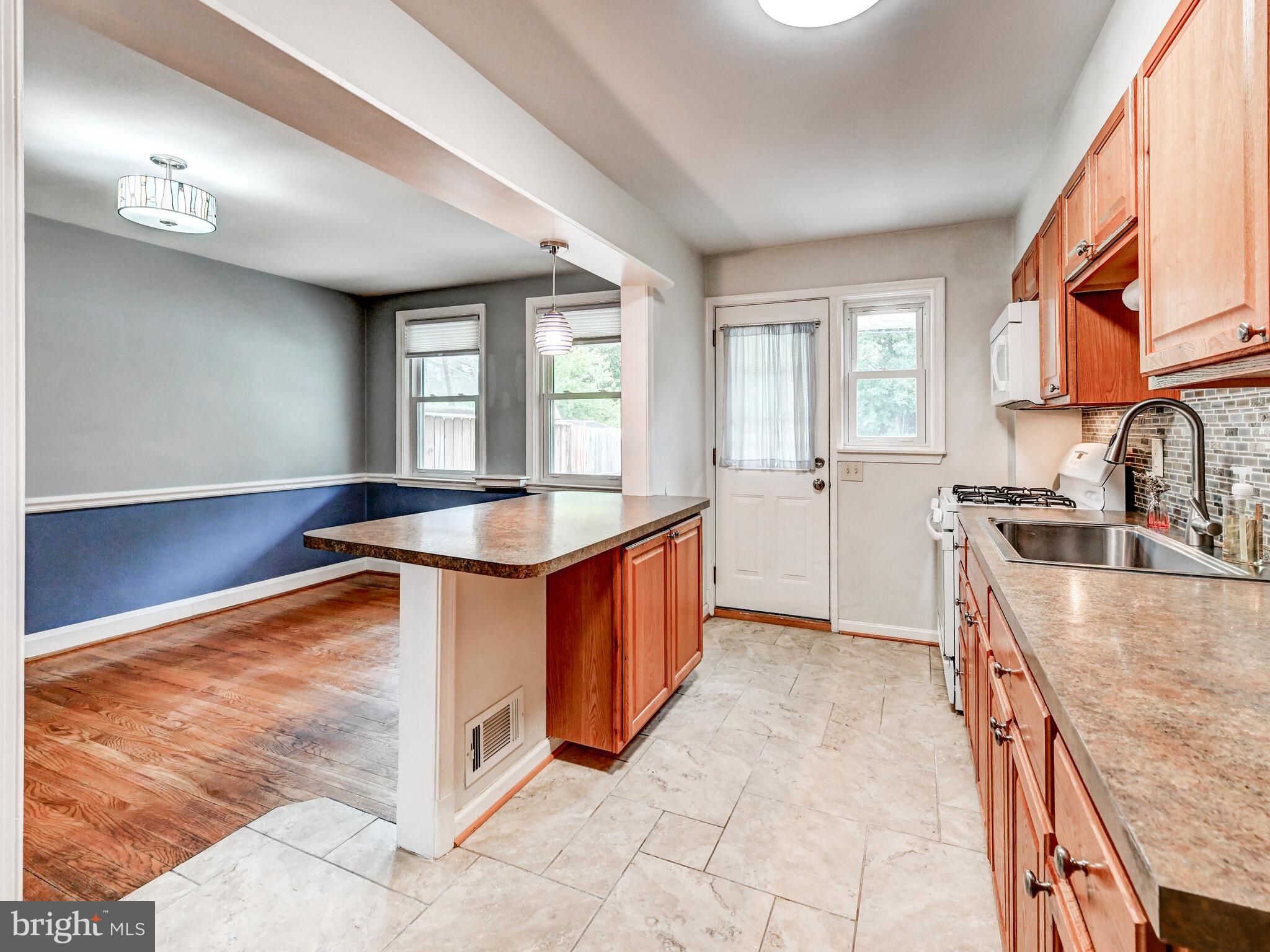 1636 Thetford Road Baltimore, MD 21286 - Photo 13 of 40 a kitchen with stainless steel appliances granite countertop a sink stove and cabinets