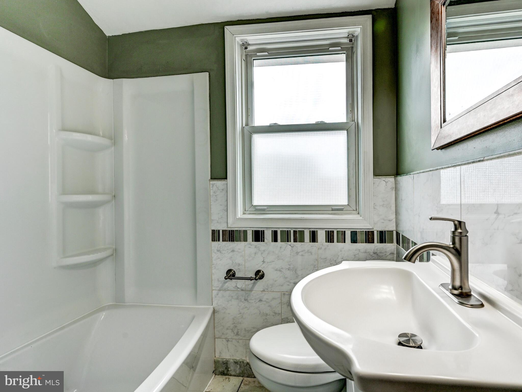 1636 Thetford Road Baltimore, MD 21286 - Photo 24 of 40 a bathroom with a sink toilet and shower