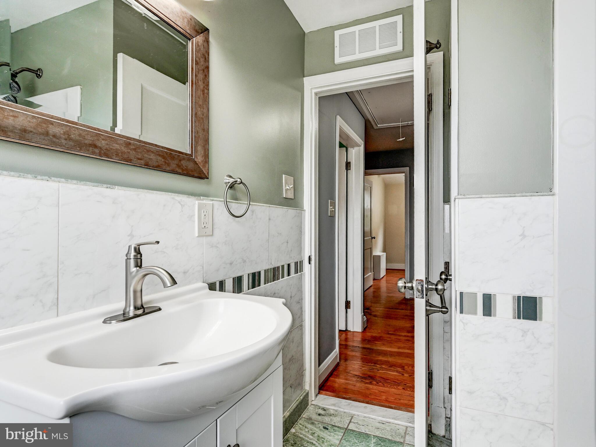 1636 Thetford Road Baltimore, MD 21286 - Photo 25 of 40 a bathroom with a sink and mirror