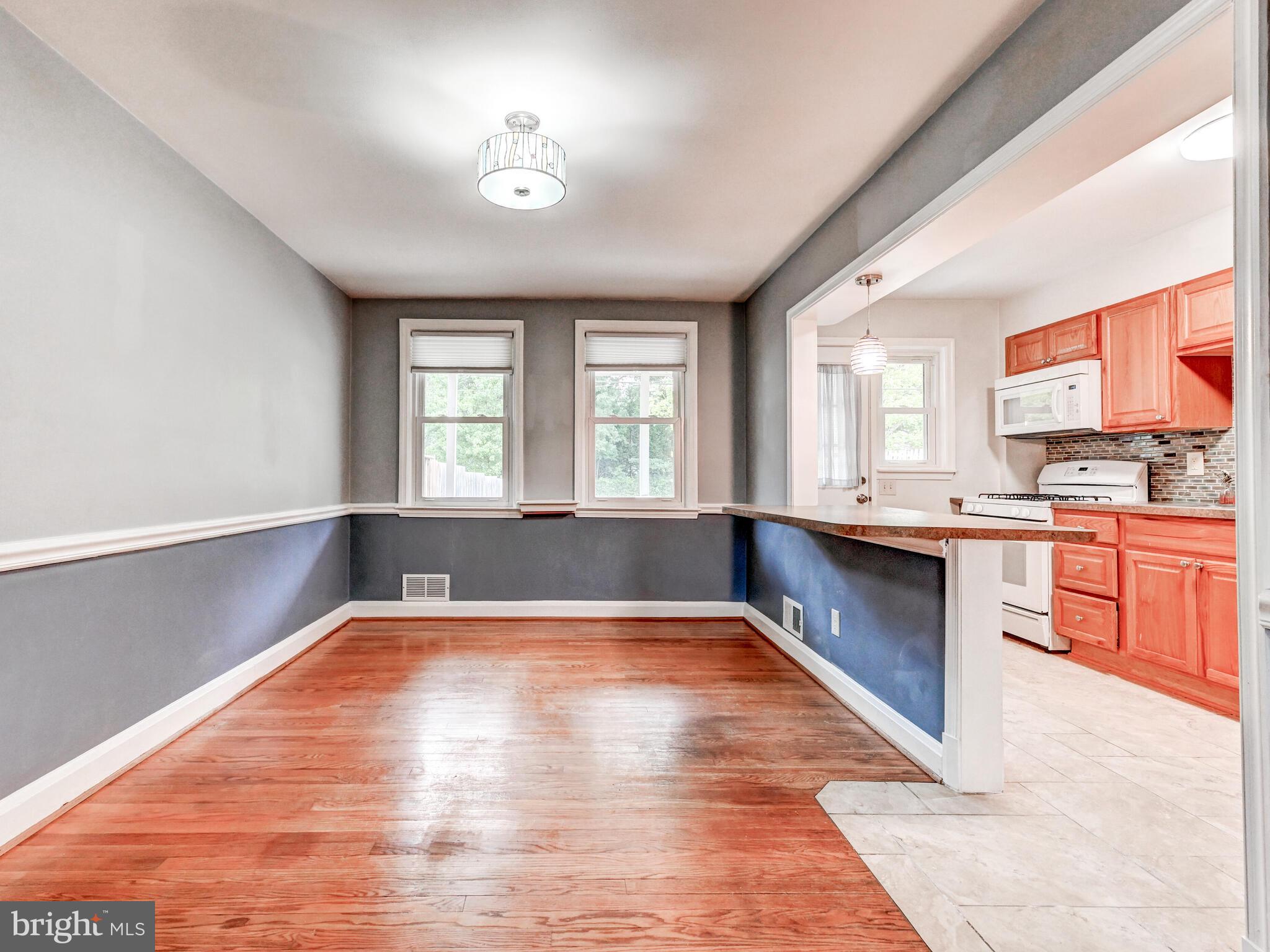 1636 Thetford Road Baltimore, MD 21286 - Photo 8 of 40 a large kitchen with stainless steel appliances granite countertop a stove a sink dishwasher and a oven with white cabinets