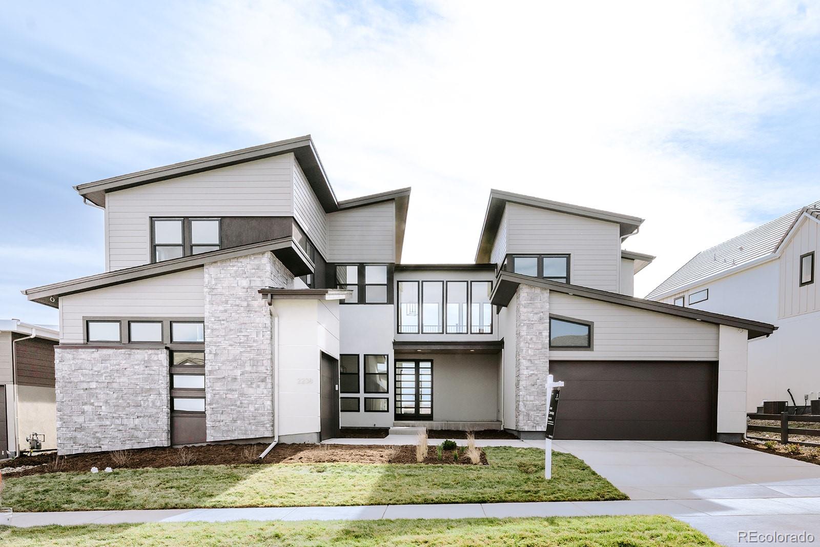 2238 Rim Ridge Drive Castle Pines, CO 80108 - Photo 1 of 1 a front view of a house with a yard and garage
