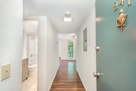a view of a hallway with wooden floor