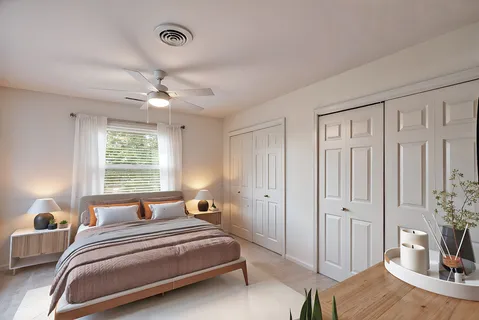 a bedroom with a bed and a window