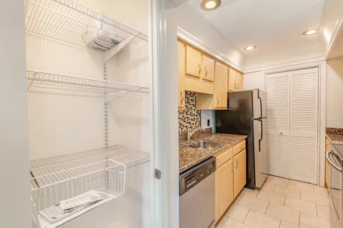 a kitchen with stainless steel appliances granite countertop a refrigerator and a sink