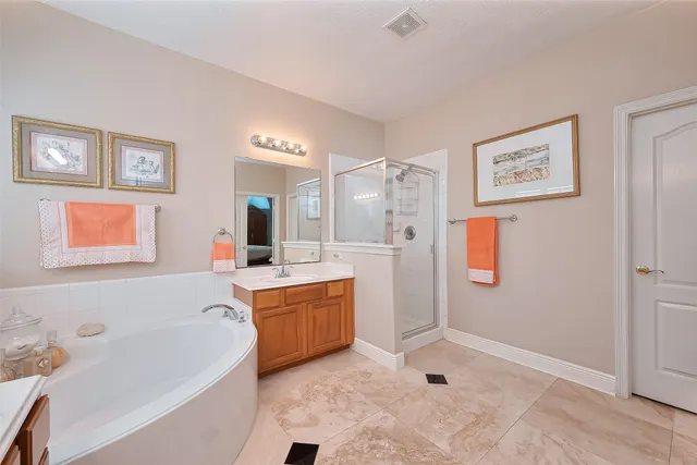 a bathroom with a tub sink and mirror