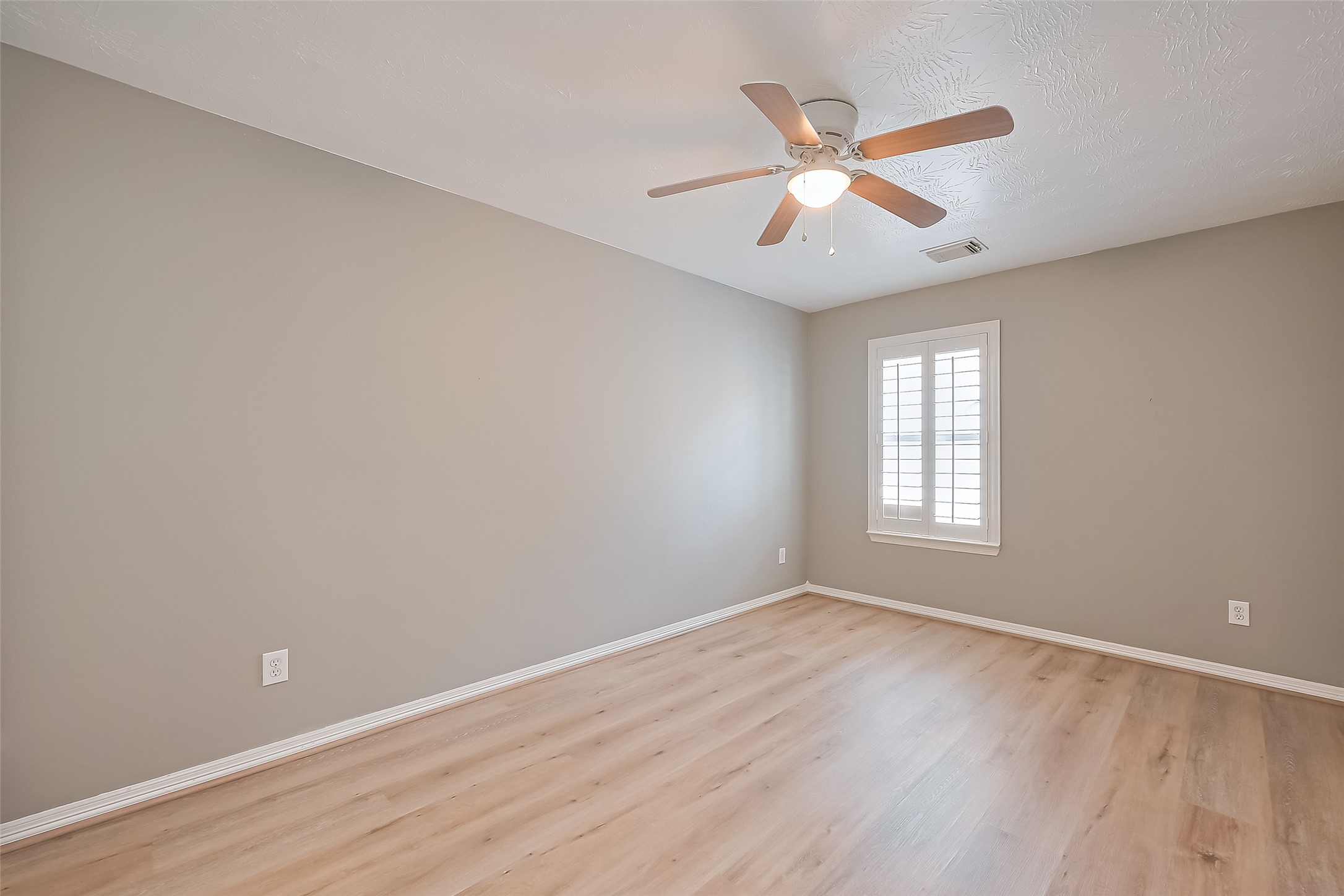 3007 Country Boy Court Spring, TX 77373 - Photo 24 of 31 an empty room with wooden floor fan and windows