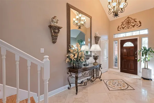 a living room with furniture and a chandelier