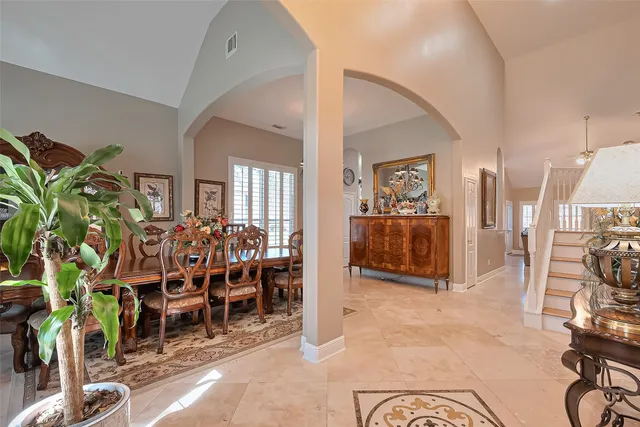 a living room with furniture and a large mirror