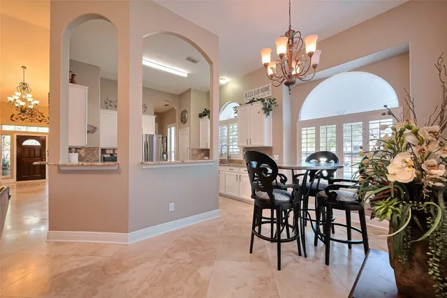 a view of a dining room with furniture and chandelier