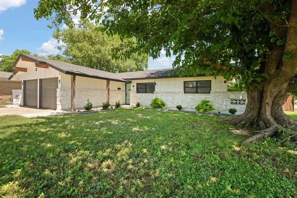 a view of a house with yard and a tree