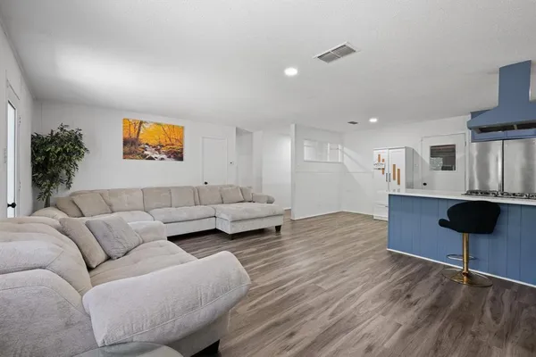 a living room with furniture and a painting