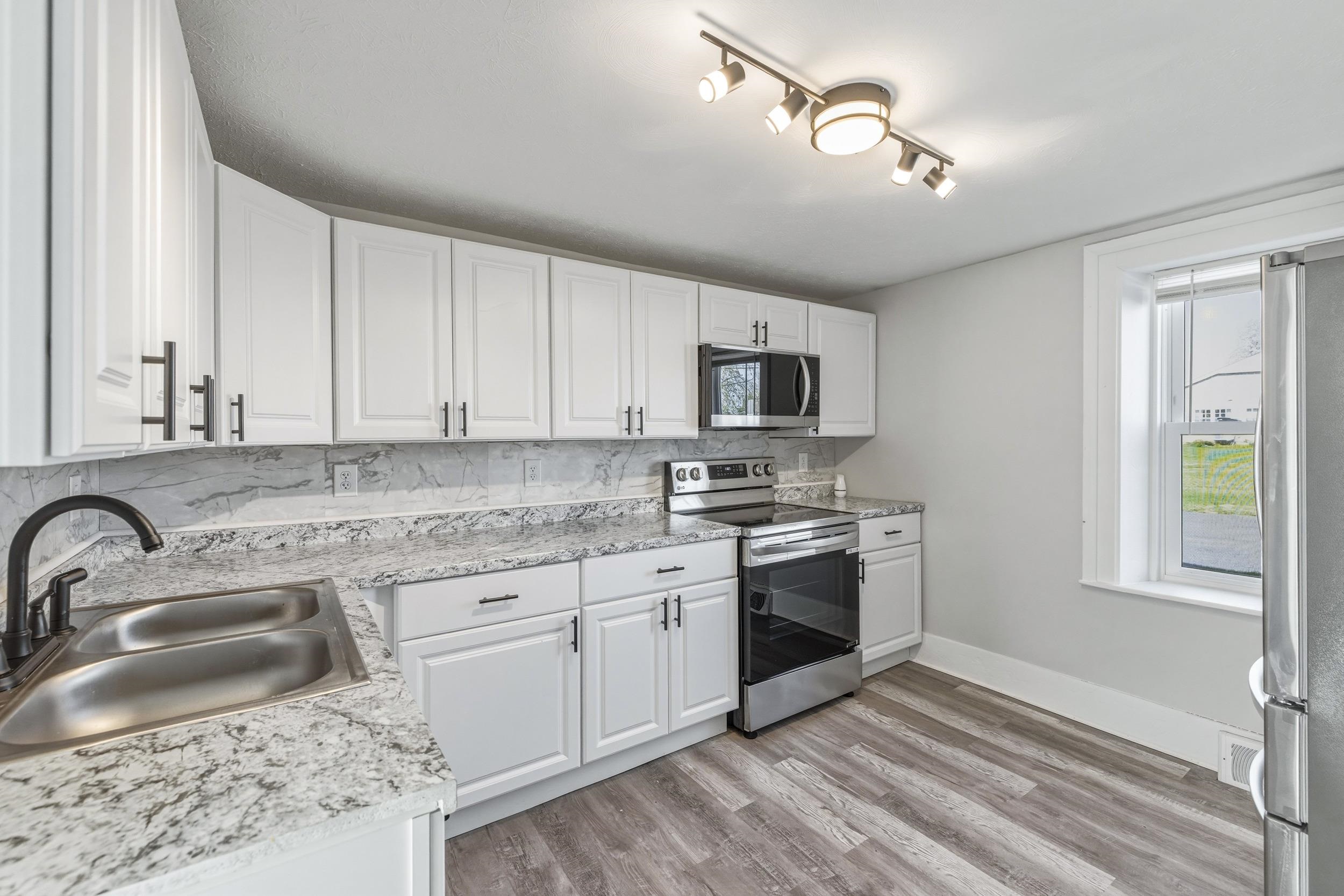 773 West Main Street Stanley, VA 22851 - Photo 2 of 66 a kitchen with stainless steel appliances granite countertop a sink and stove top oven