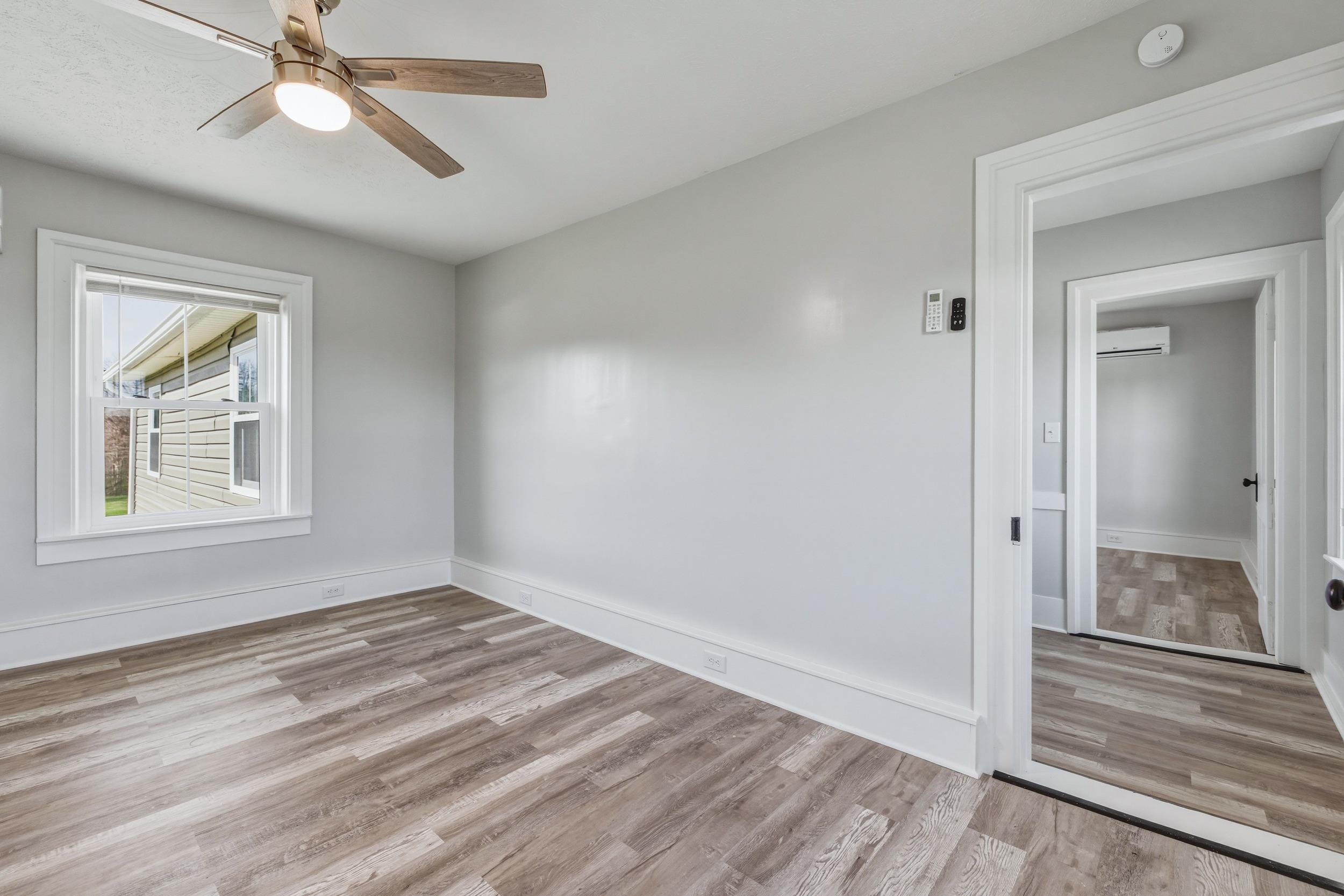 773 West Main Street Stanley, VA 22851 - Photo 22 of 66 wooden floor in an empty room with a window