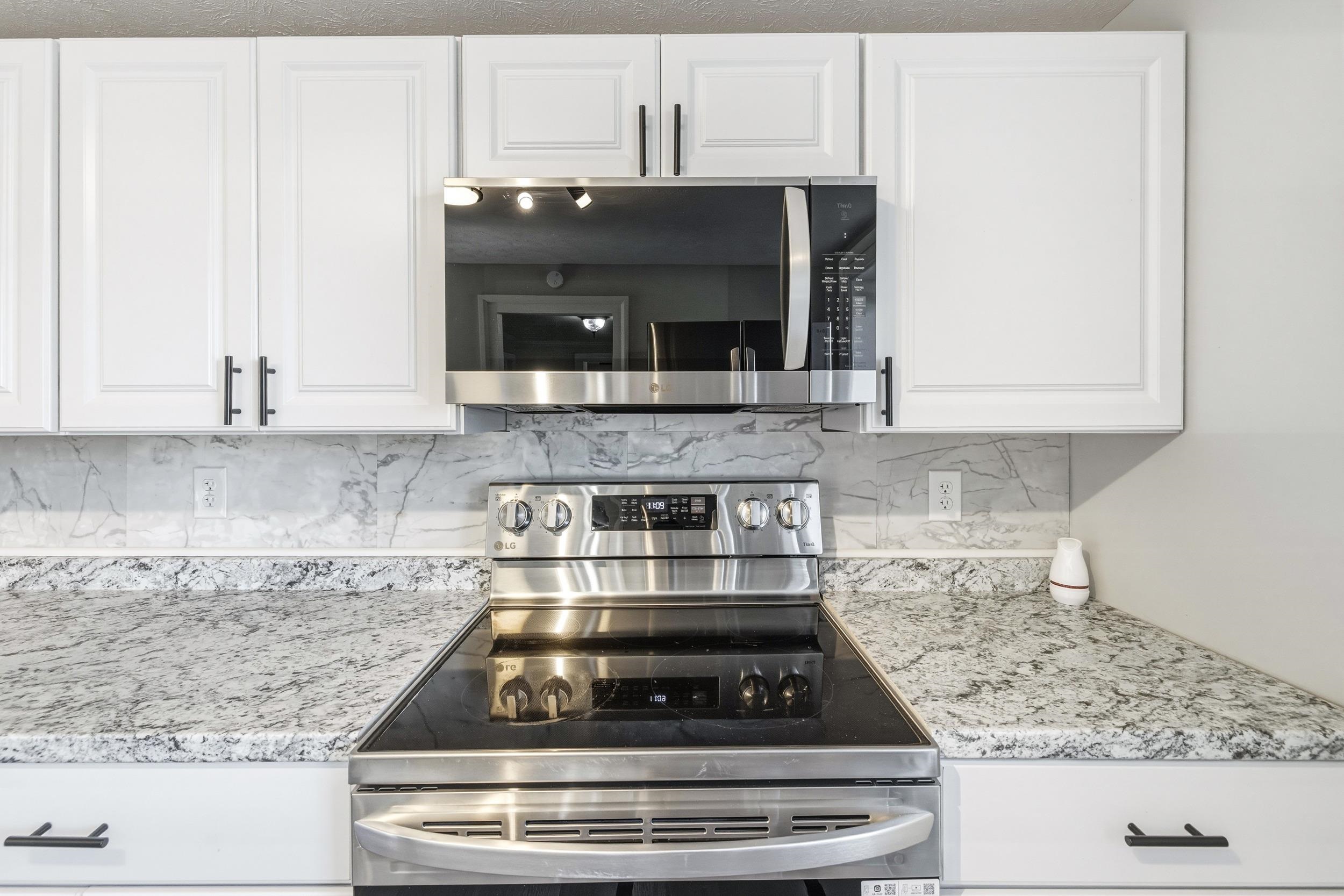 773 West Main Street Stanley, VA 22851 - Photo 6 of 66 a kitchen with granite countertop a stove and a white cabinets