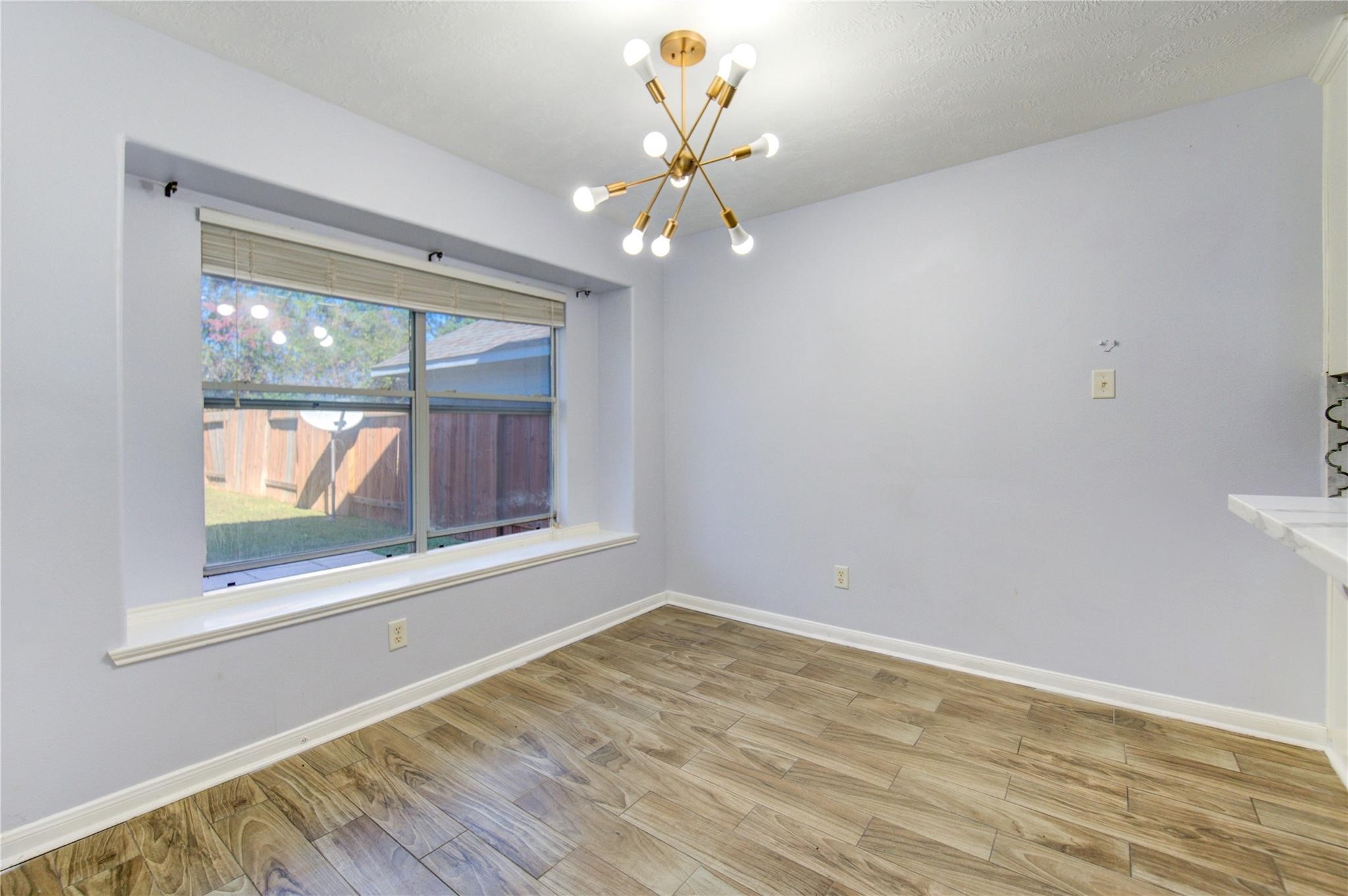 19334 Strathmore Pl Lane Katy, TX 77449 - Photo 21 of 48 a view of an empty room with wooden floor and a window