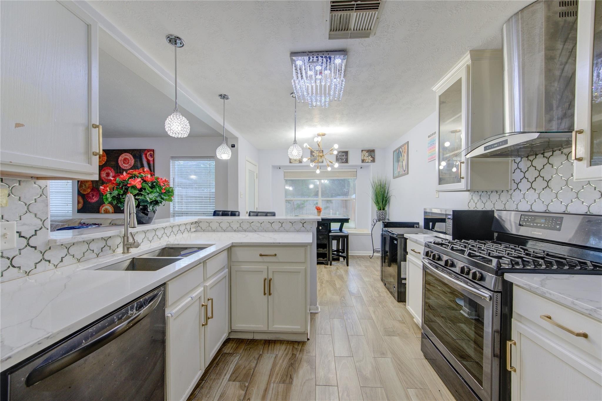 19334 Strathmore Pl Lane Katy, TX 77449 - Photo 25 of 48 a kitchen with a sink cabinets and wooden floor