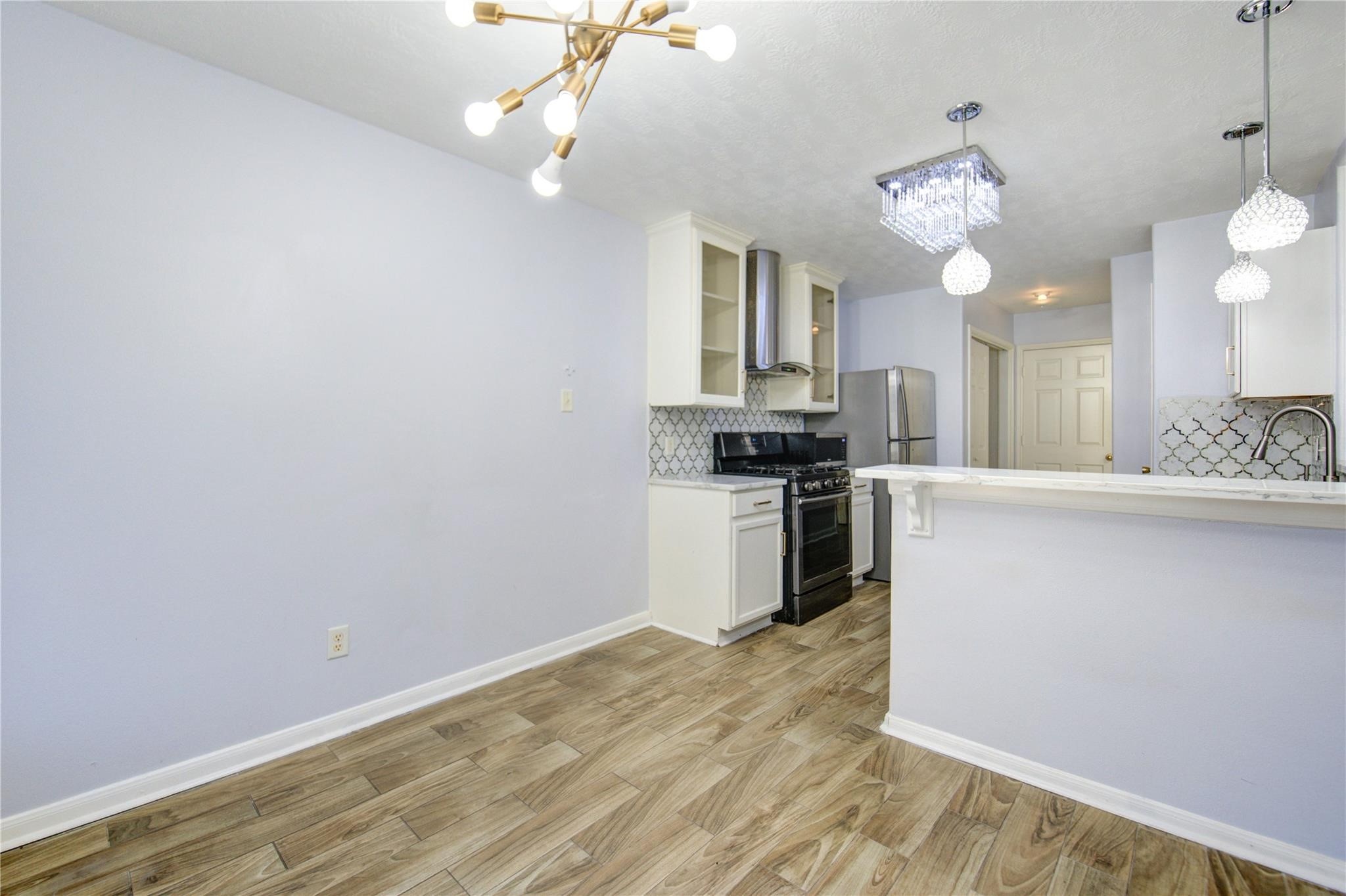 19334 Strathmore Pl Lane Katy, TX 77449 - Photo 28 of 48 a view of a kitchen with microwave and stove