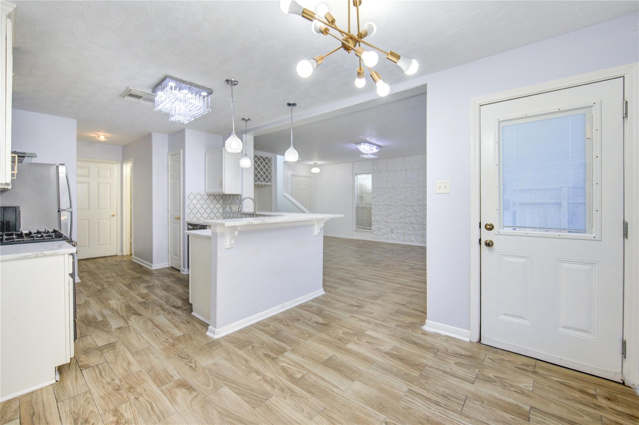 19334 Strathmore Pl Lane Katy, TX 77449 - Photo 31 of 48 a view of a kitchen and a chandelier fan
