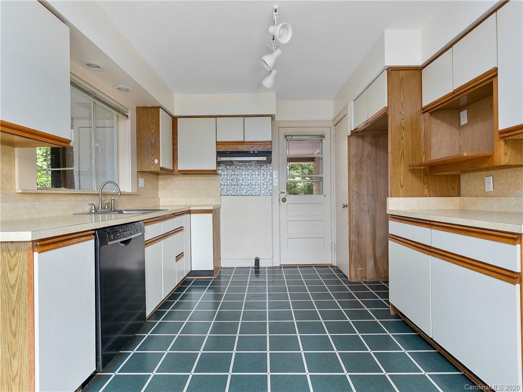 434 Hogback Mountain Road Tryon, NC 28782 - Photo 11 of 37 a kitchen with a sink a stove a microwave and cabinets