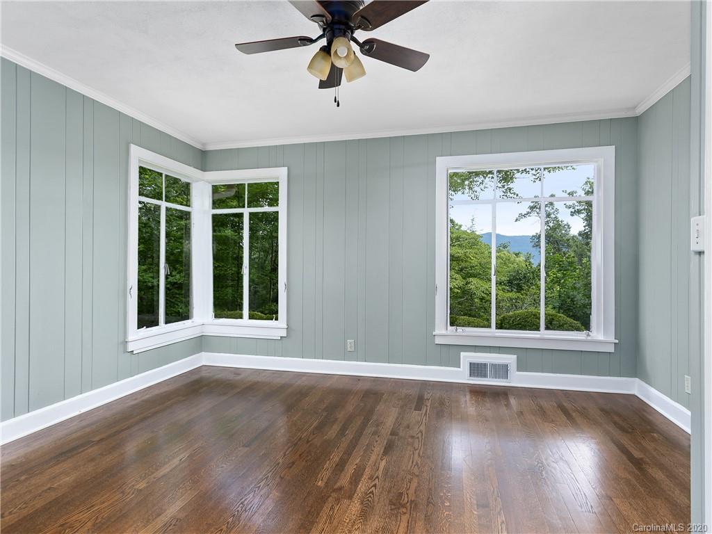 434 Hogback Mountain Road Tryon, NC 28782 - Photo 15 of 37 a view of an empty room with wooden floor and a window