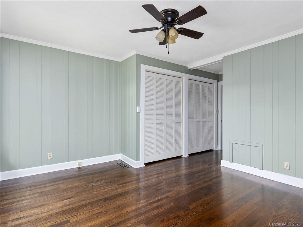 434 Hogback Mountain Road Tryon, NC 28782 - Photo 16 of 37 a view of an empty room with wooden floor and a ceiling fan