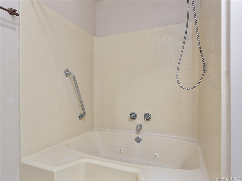 434 Hogback Mountain Road Tryon, NC 28782 - Photo 18 of 37 a bathroom with a bath tub with a shower