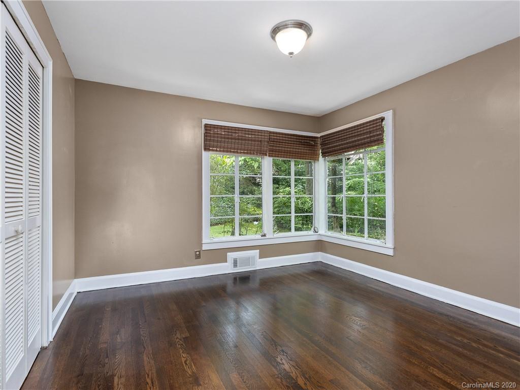 434 Hogback Mountain Road Tryon, NC 28782 - Photo 19 of 37 an empty room with wooden floor and windows