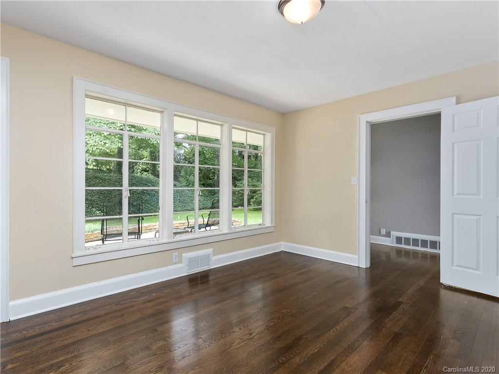 434 Hogback Mountain Road Tryon, NC 28782 - Photo 23 of 37 a view of an empty room with wooden floor and a window