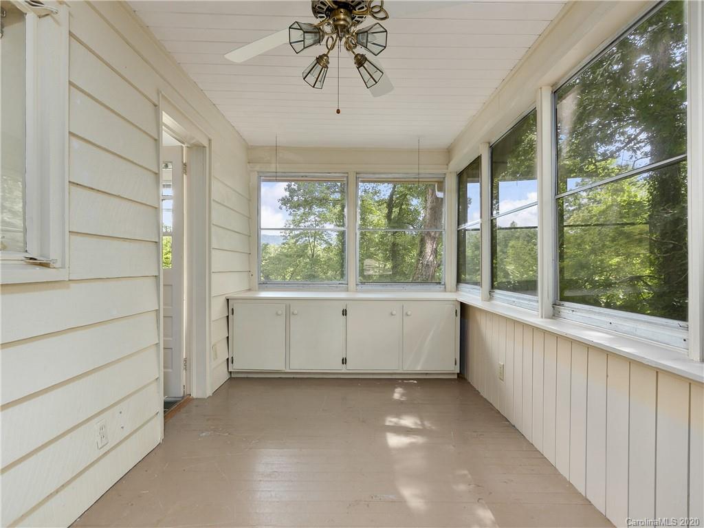 434 Hogback Mountain Road Tryon, NC 28782 - Photo 26 of 37 a view of a big room with windows and chandelier