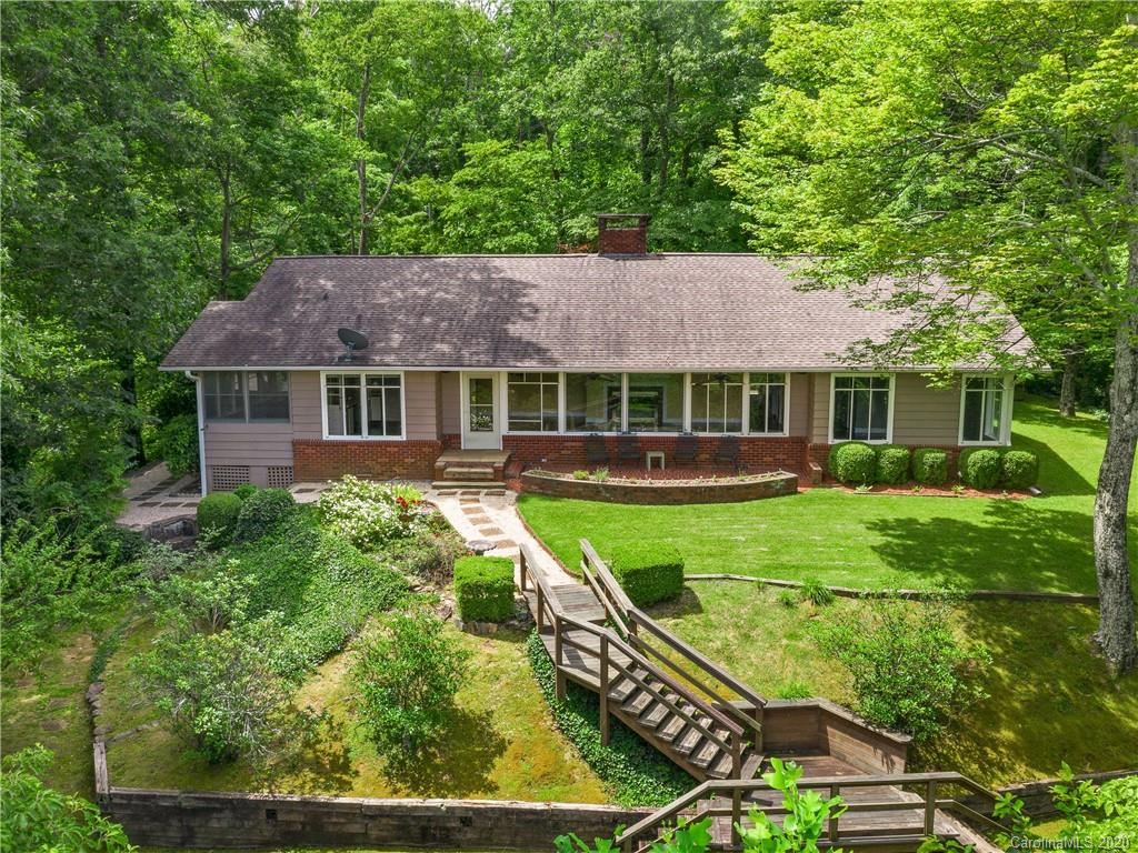 434 Hogback Mountain Road Tryon, NC 28782 - Photo 28 of 37 a front view of a house with a yard table and chairs