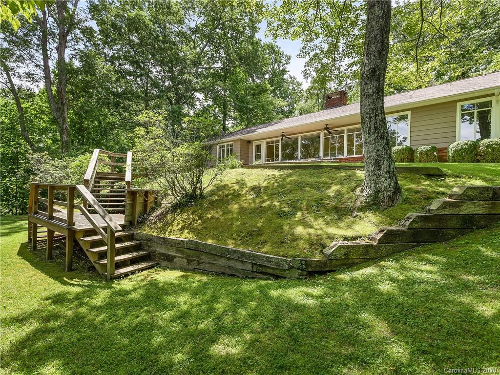 434 Hogback Mountain Road Tryon, NC 28782 - Photo 30 of 37 a front view of a house with a yard table and chairs