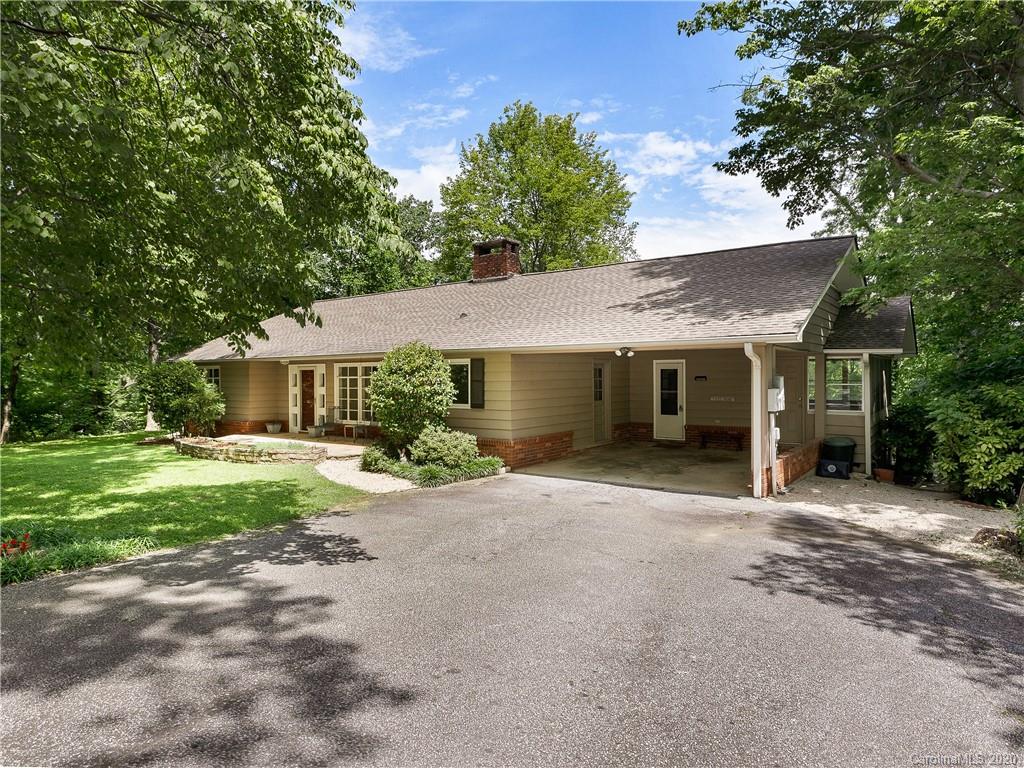 434 Hogback Mountain Road Tryon, NC 28782 - Photo 4 of 37 a front view of a house with a yard and porch