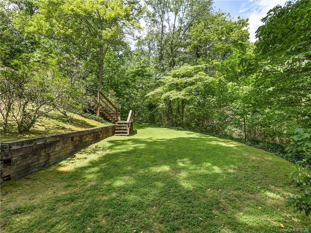 434 Hogback Mountain Road Tryon, NC 28782 - Photo 36 of 37 a garden with trees in the background